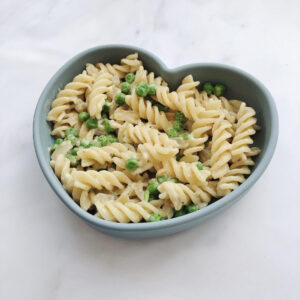 pasta and peas in a blue heart plate