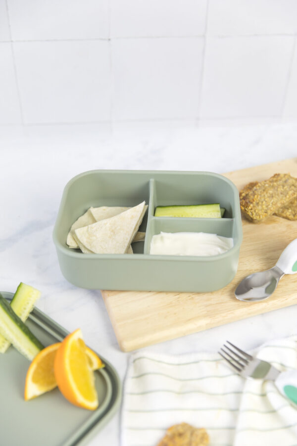 sage lunchbox on a chopping board with food inside