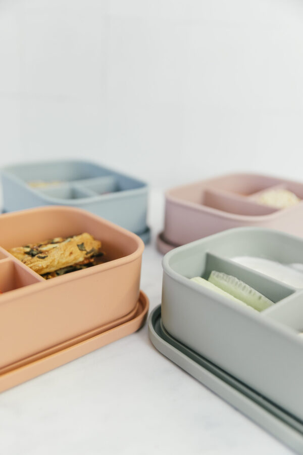 Four bento lunchboxes in dusty rose, dusty lilac, sage and dusty blue